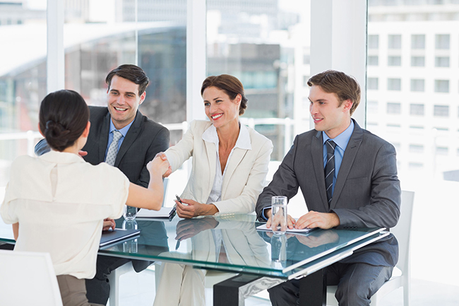 Handshake to seal a deal after a job recruitment meeting in an office